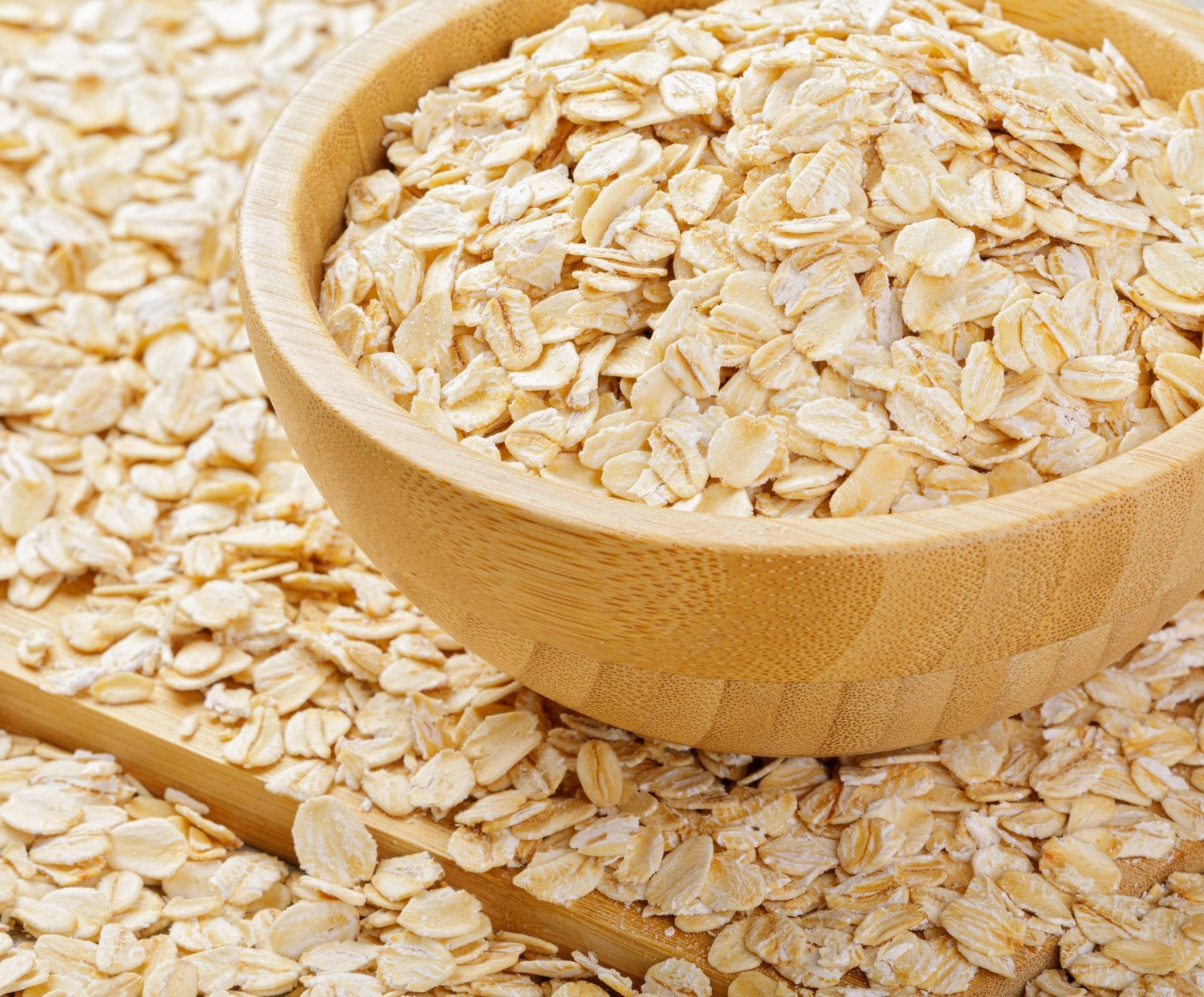 Wooden bowl overflowing with oats. 