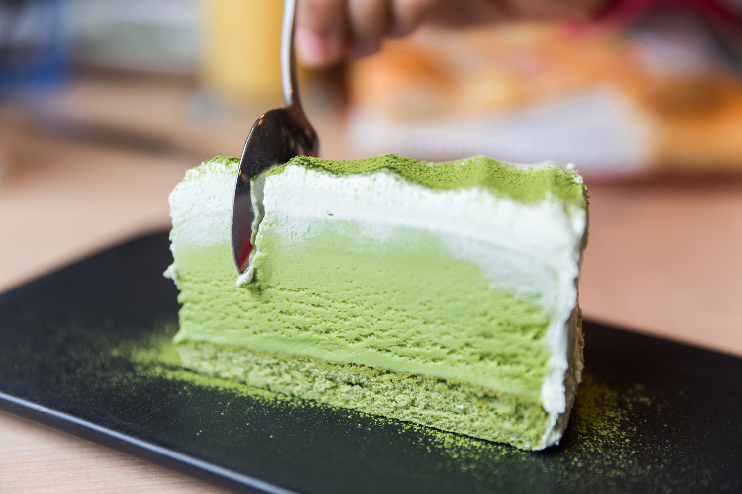 Creamy vibrant matcha cake dessert, with a mousse-like texture.